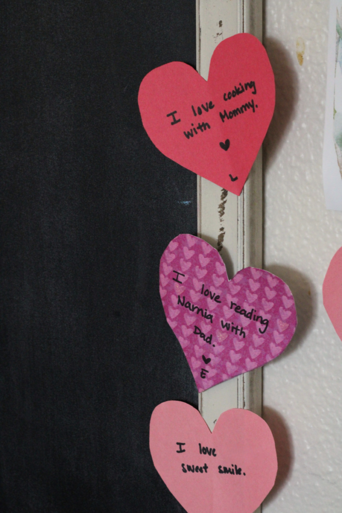 paper hearts with writing describing the love between family members