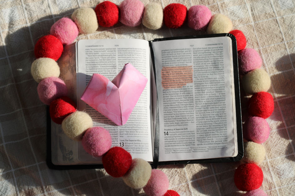 bible open to 1 corinthians 13 with paper heart and garland